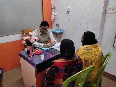  Dr. Abhijit Bhaumik with his patients in his clinic.